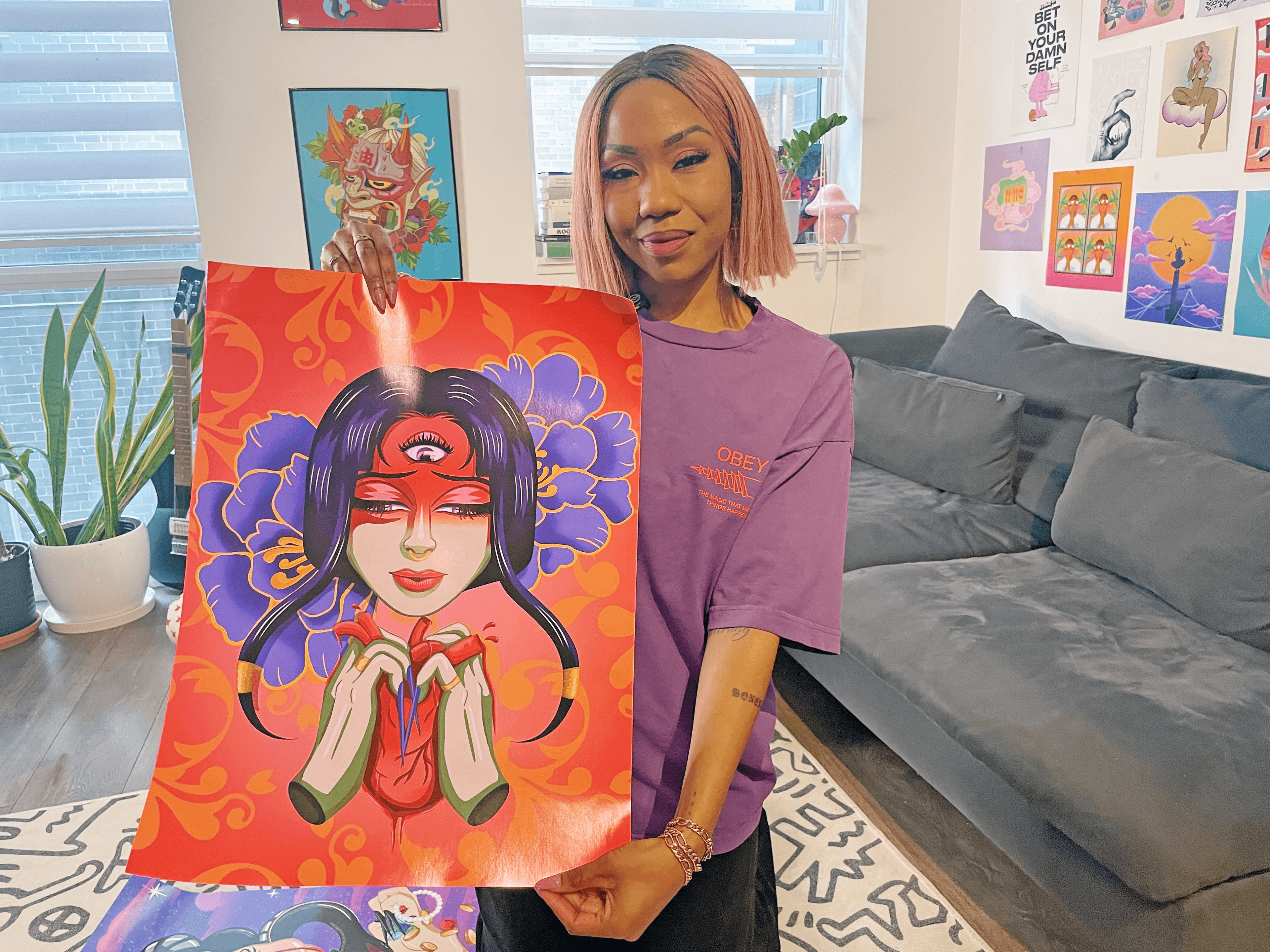 Sadé Powell showcasing one of her vibrant illustrations, printed by TPH