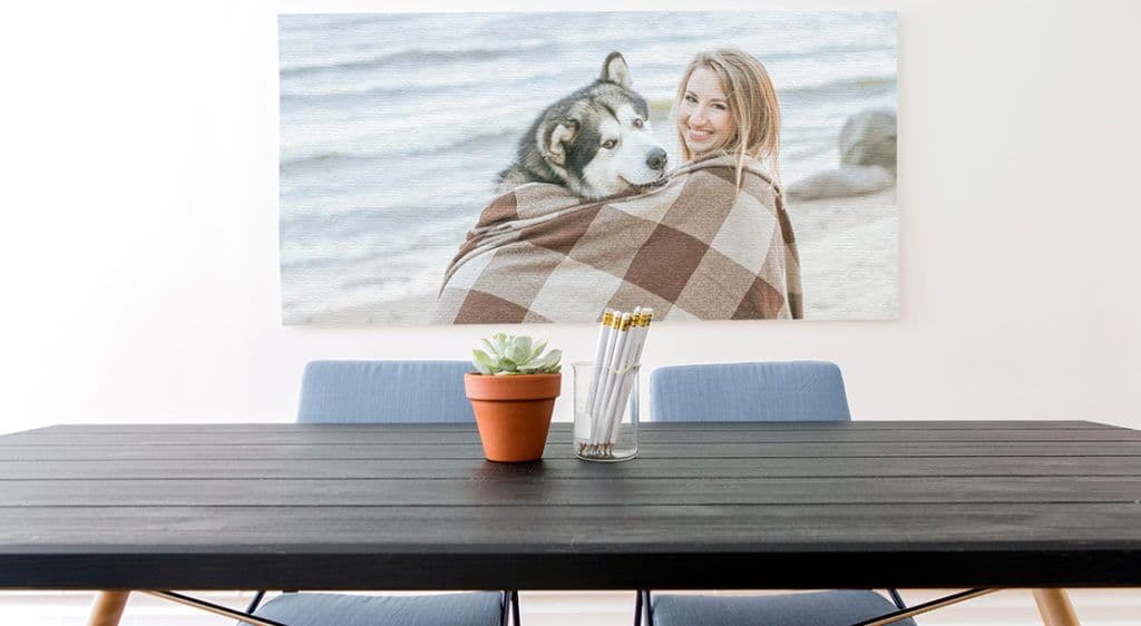 Photo of woman and dog on the beach hung over a dining room table