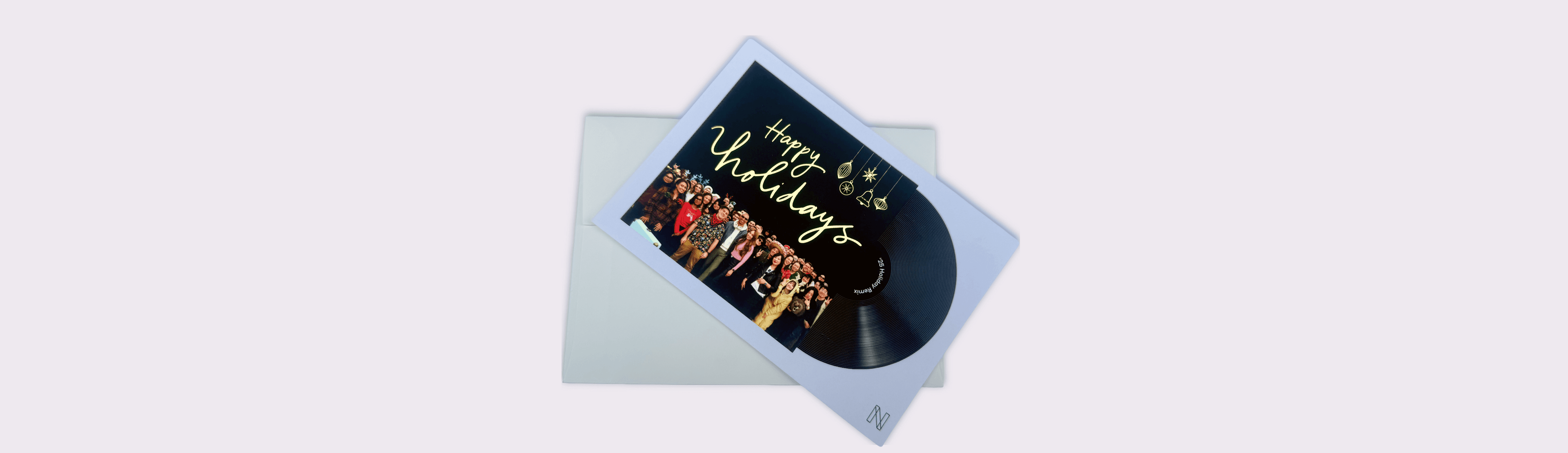 Custom holiday greeting card featuring a group photo and gold foil “Happy Holidays” text, paired with a black vinyl record design for a unique branded gift.