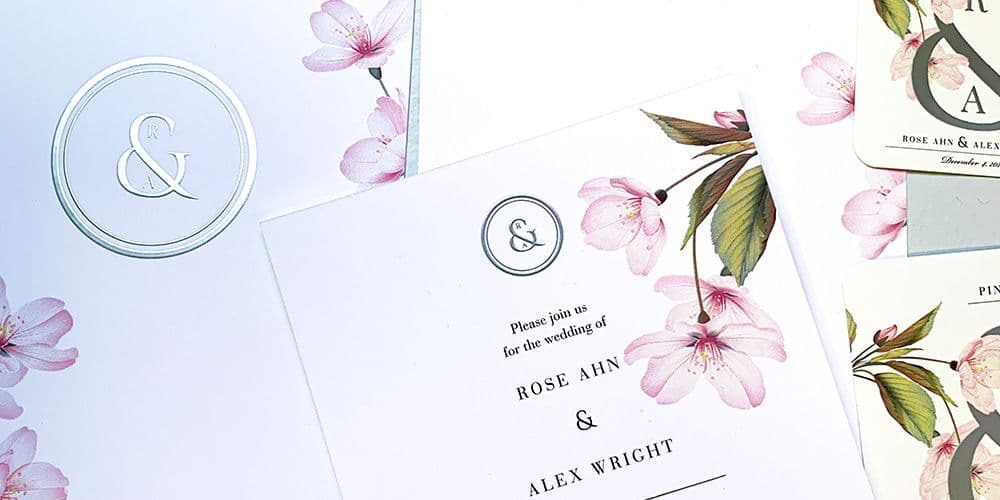 Elegant spread of wedding invitations with floral and metal decals