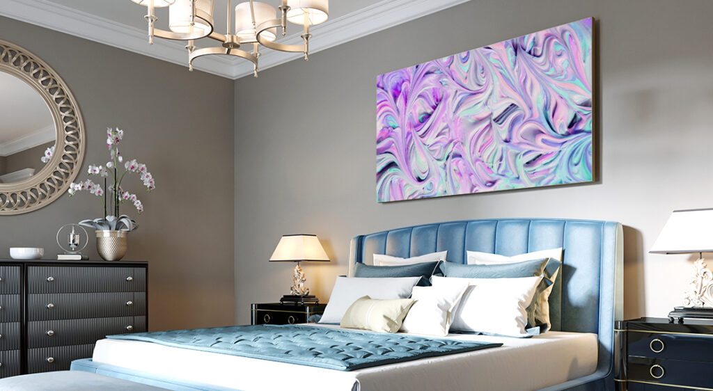 A large, oversized canvas print of abstract purple, blue and white swirls hangs above a bed in a large bedroom with grey walls. 