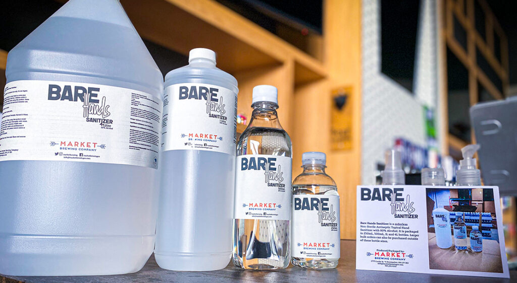 Bare Hands Sanitizer products in each available size are lined up beside a promotional postcard for the sanitizer line.