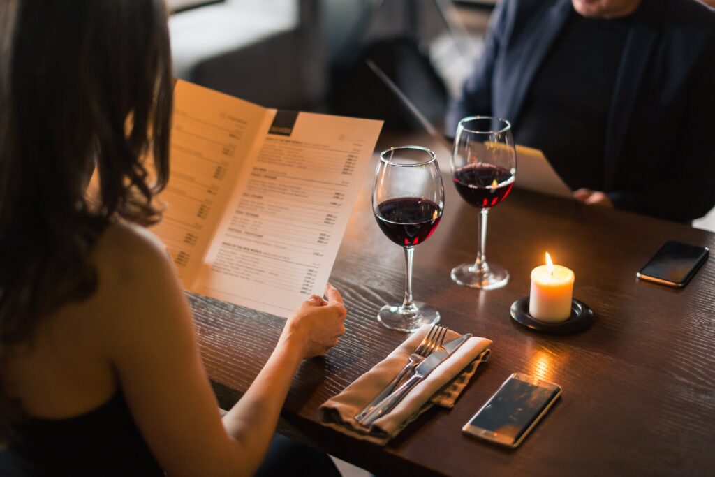 Woman dining at restaurant during holiday season.