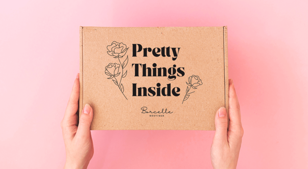 Hands hold product packaging that looks like a subscription box with the words "Pretty Things Inside" in a bold black font.